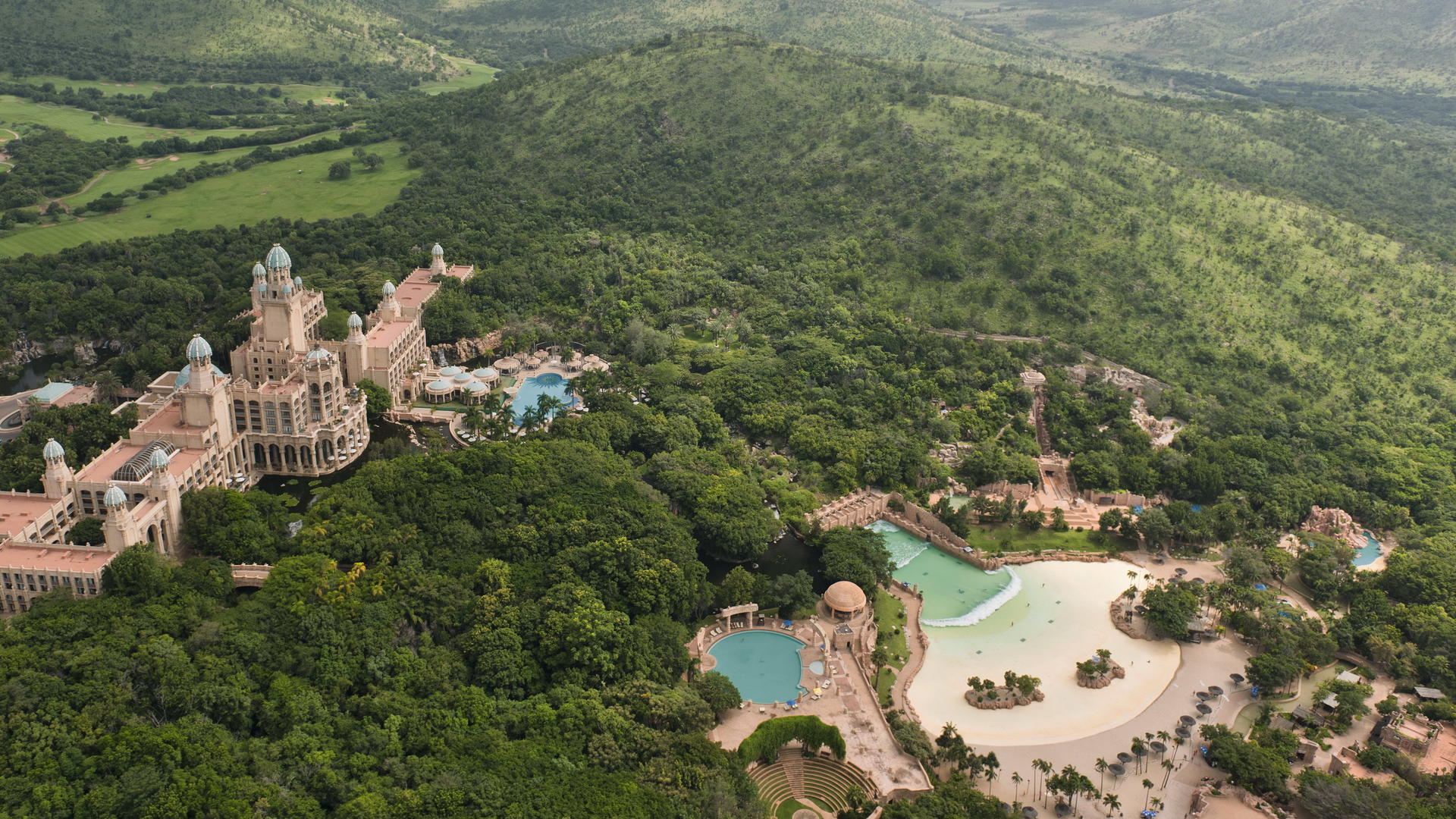 The Palace of the Lost City at Sun City Resort with luxury swimming pools and palm trees